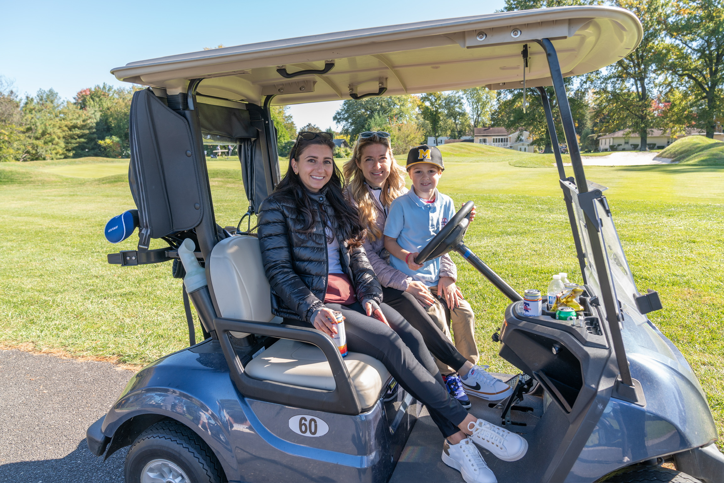 Blake Driving a Golf Cart with family
